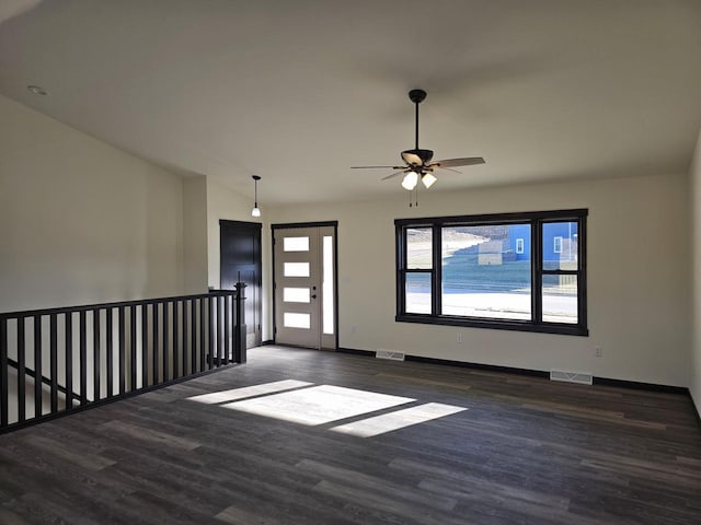 interior space featuring dark hardwood / wood-style floors, vaulted ceiling, and ceiling fan