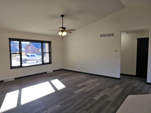 spare room with lofted ceiling, ceiling fan, and dark wood-type flooring