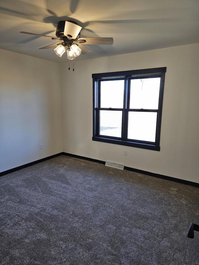 carpeted spare room featuring ceiling fan