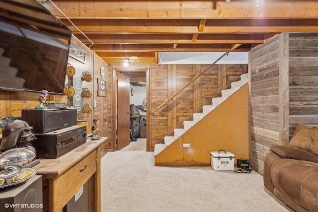 basement with carpet flooring and wooden walls