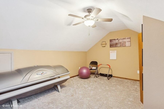 interior space with ceiling fan, vaulted ceiling, and light carpet