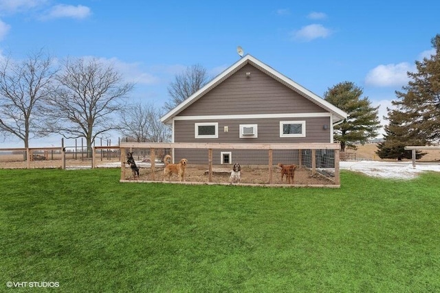 rear view of house featuring a yard