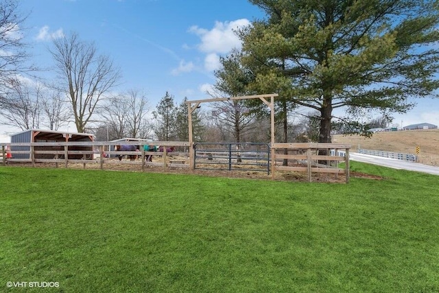 view of yard with a rural view