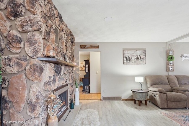 living room with a fireplace and hardwood / wood-style floors