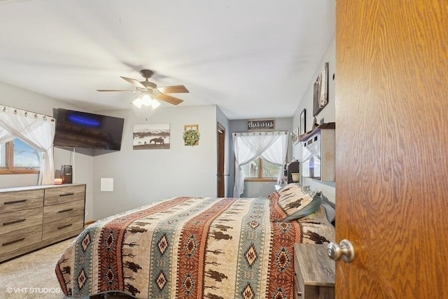 bedroom featuring ceiling fan and carpet