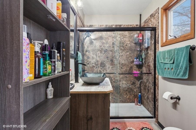 bathroom featuring walk in shower and vanity