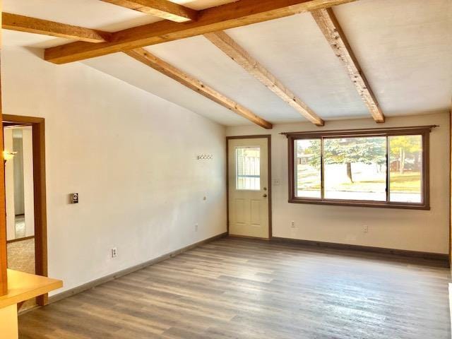 interior space featuring vaulted ceiling with beams and hardwood / wood-style floors