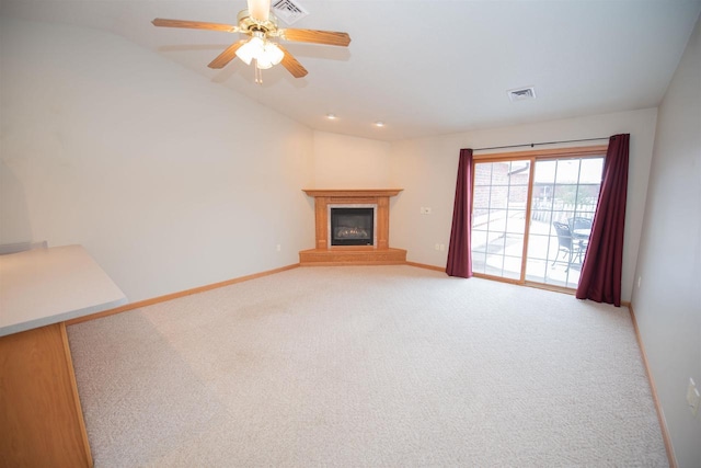 unfurnished living room with ceiling fan, carpet, and vaulted ceiling