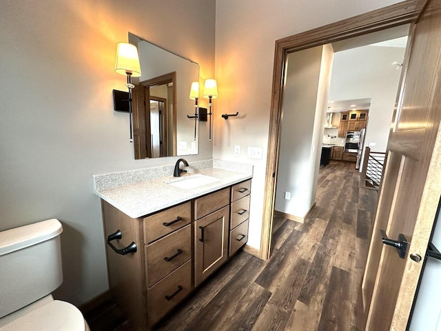 bathroom with vanity, toilet, and wood-type flooring