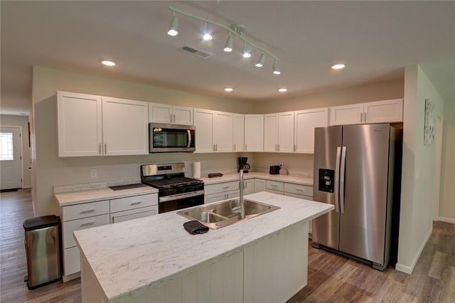 kitchen featuring white cabinetry, sink, an island with sink, and appliances with stainless steel finishes