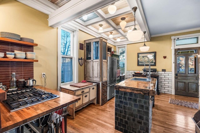 kitchen featuring hanging light fixtures, stainless steel appliances, beam ceiling, coffered ceiling, and sink