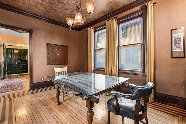 dining room with light wood-type flooring and crown molding