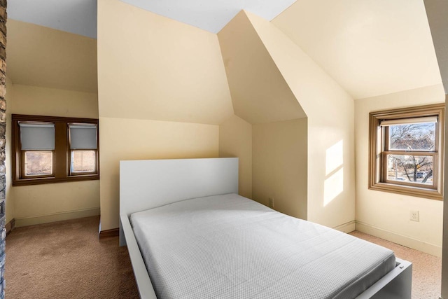 carpeted bedroom featuring lofted ceiling