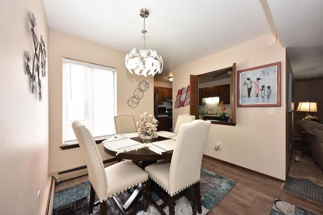 dining space with dark hardwood / wood-style flooring and an inviting chandelier