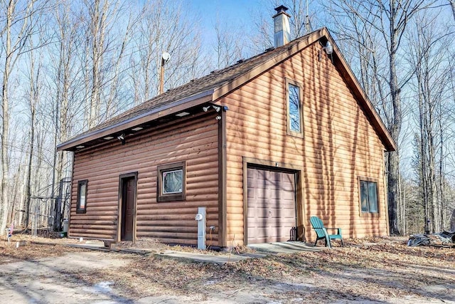 view of side of home featuring a garage