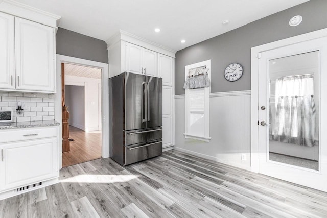 616 Elk St, Sabula, IA 52070 - kitchen featuring light hardwood / wood-style flooring, light stone countertops, decorative backsplash, high end refrigerator, and white cabinetry