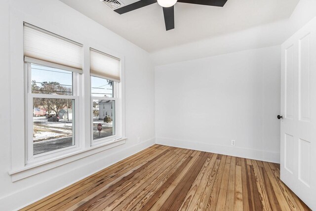 616 Elk St, Sabula, IA 52070 - empty room featuring ceiling fan and hardwood / wood-style floors
