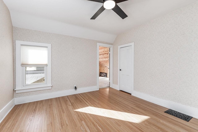 616 Elk St, Sabula, IA 52070 - unfurnished room with hardwood / wood-style flooring, ceiling fan, and vaulted ceiling