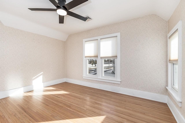 616 Elk St, Sabula, IA 52070 - empty room featuring ceiling fan, lofted ceiling, and wood-type flooring