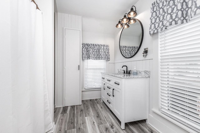 616 Elk St, Sabula, IA 52070 - bathroom featuring hardwood / wood-style flooring and vanity