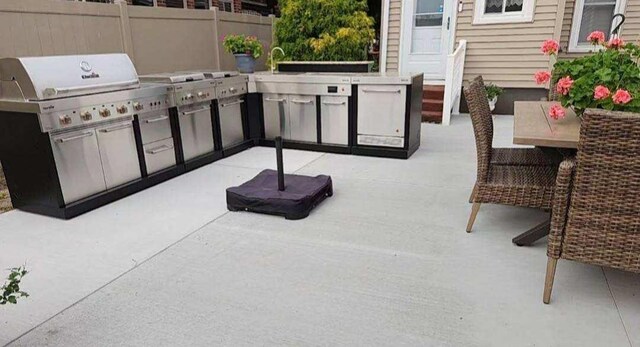 616 Elk St, Sabula, IA 52070 - view of patio with exterior kitchen, a grill, and sink