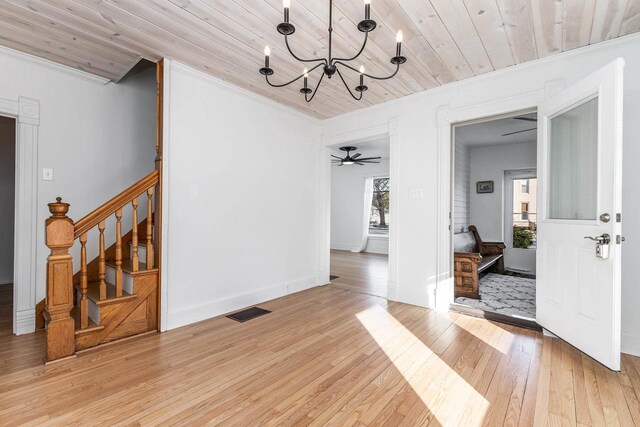 616 Elk St, Sabula, IA 52070 - interior space with ceiling fan with notable chandelier, light wood-type flooring, wooden ceiling, and ornamental molding