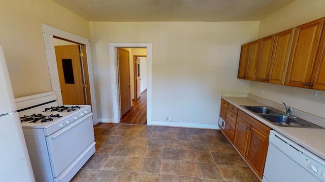 kitchen featuring white appliances and sink