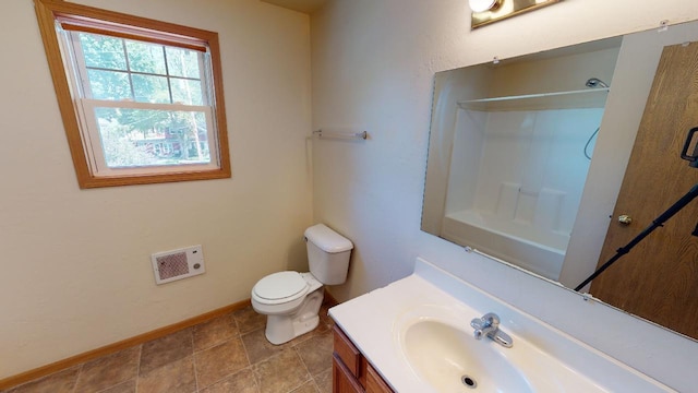 bathroom with vanity, toilet, and walk in shower