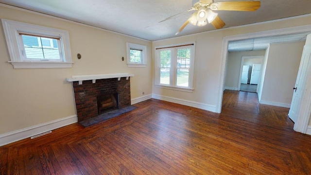 living room with a fireplace, dark hardwood / wood-style flooring, ceiling fan, and crown molding