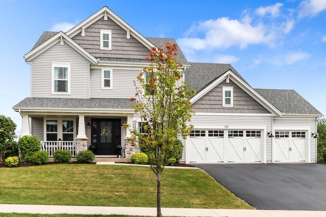 craftsman-style home featuring a porch, a garage, and a front yard