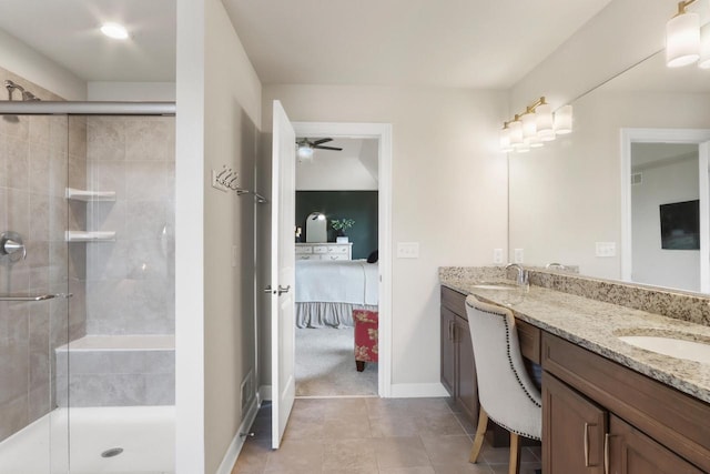 bathroom with tile patterned floors, ceiling fan, walk in shower, and vanity