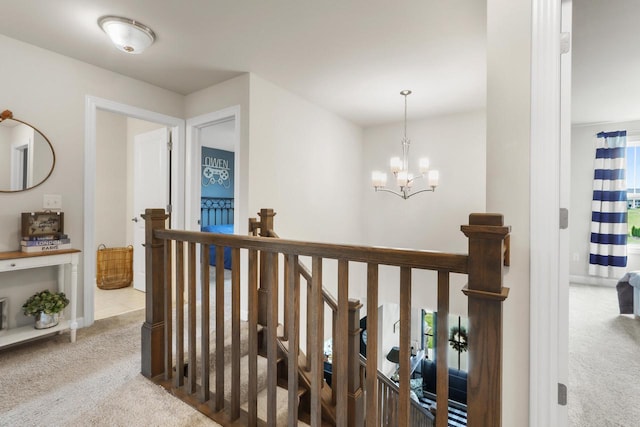 hall with a chandelier and carpet floors