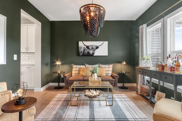 sitting room with light hardwood / wood-style flooring and a notable chandelier