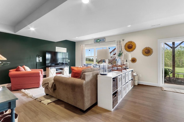 living room with hardwood / wood-style flooring and a wealth of natural light