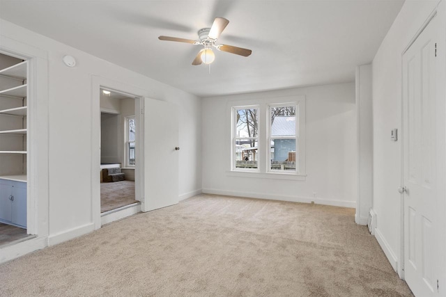 unfurnished bedroom featuring light carpet and ceiling fan