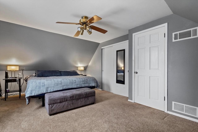 carpeted bedroom with ceiling fan and vaulted ceiling