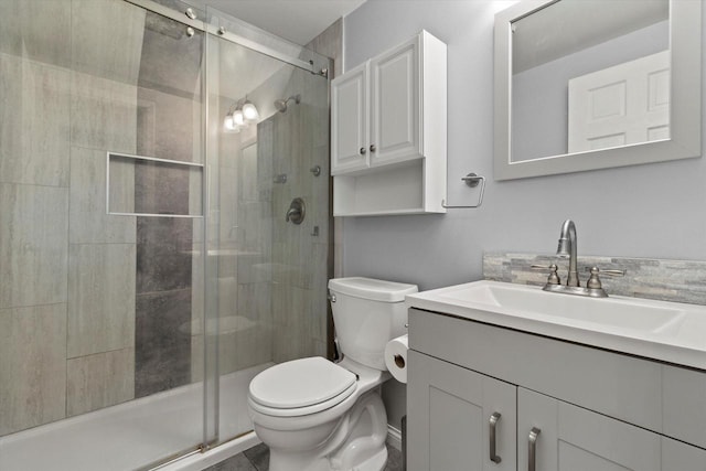 bathroom with vanity, toilet, and an enclosed shower