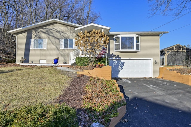 view of front of property featuring a garage and a front yard