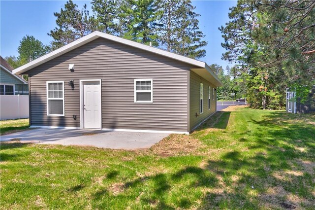 10274 Olker Rd, Hayward, WI 54843 - back of property featuring a lawn and a patio