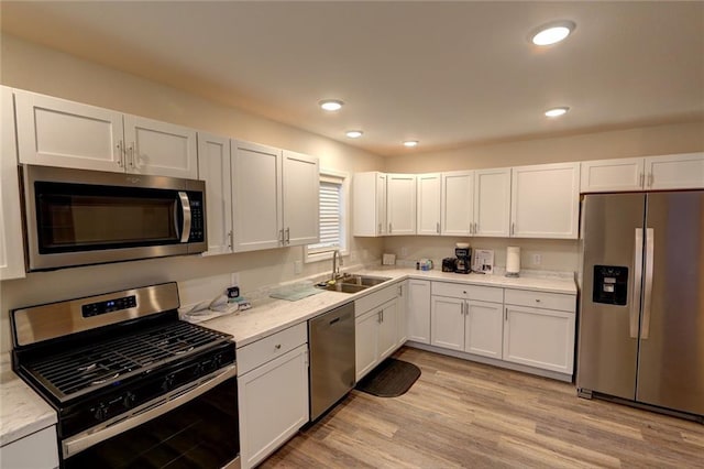 kitchen featuring white cabinets, stainless steel appliances, and sink