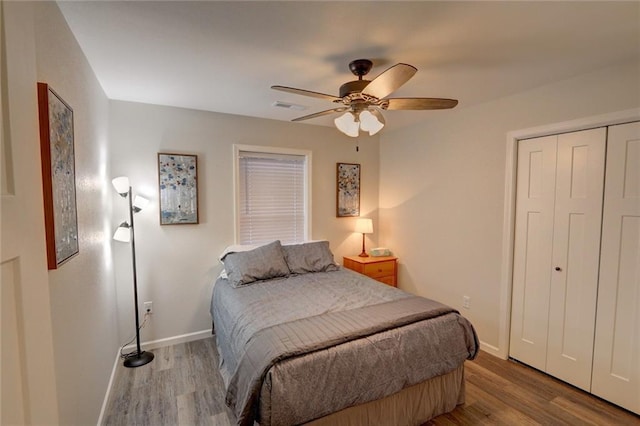 bedroom featuring light wood-type flooring, a closet, and ceiling fan