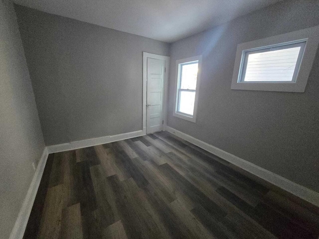 empty room with dark wood-type flooring