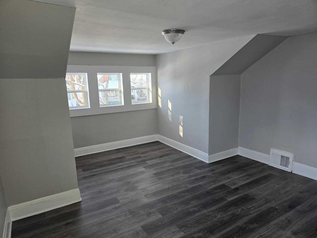 additional living space featuring dark hardwood / wood-style floors