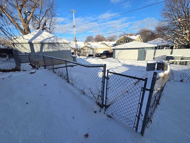 yard covered in snow with an outdoor structure