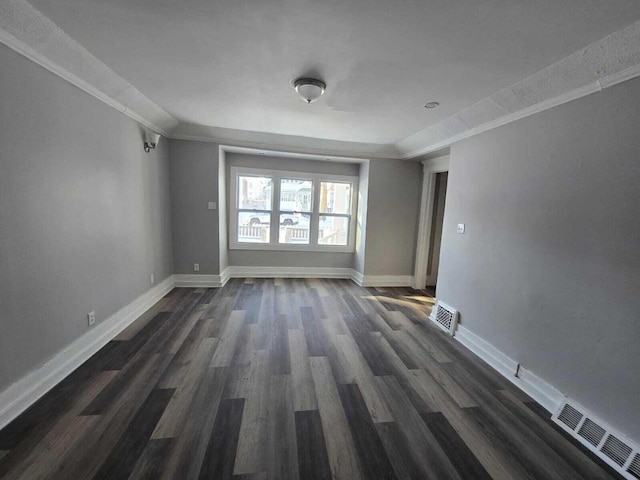 spare room with dark hardwood / wood-style floors and ornamental molding