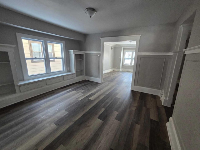 unfurnished living room with dark hardwood / wood-style floors