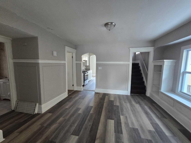 unfurnished living room with dark hardwood / wood-style floors