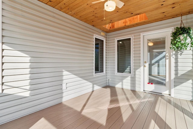 wooden deck featuring ceiling fan