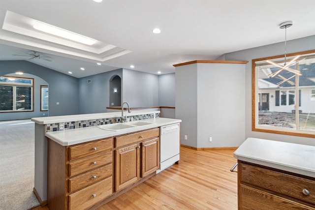 kitchen with ceiling fan, dishwasher, sink, pendant lighting, and light wood-type flooring