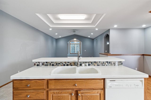 kitchen featuring dishwasher, ceiling fan, a kitchen island with sink, and sink